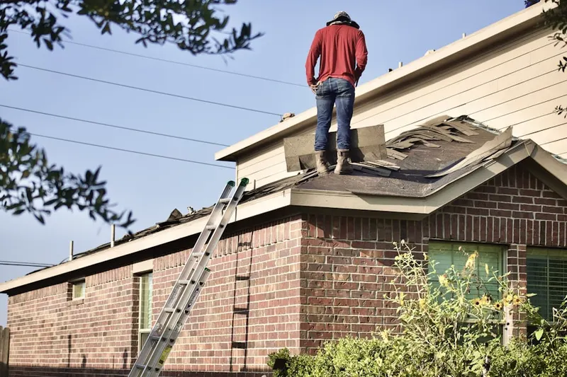 Professional roofer working on a residential roof in Rives